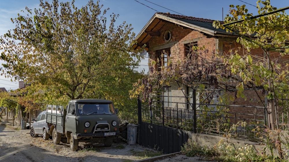 a couple of cars parked in front of a house