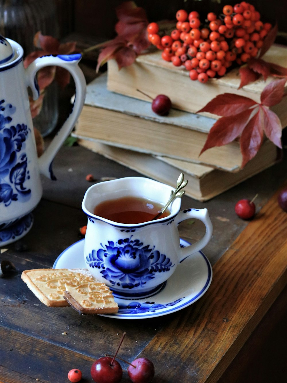 a cup of coffee and a plate of bread and a plate of fruit