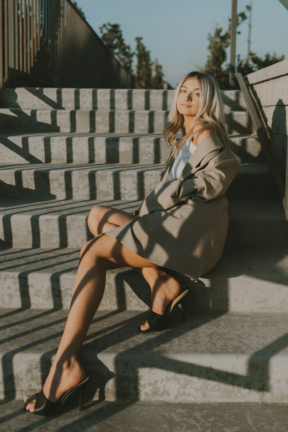 a woman sitting on a stone wall