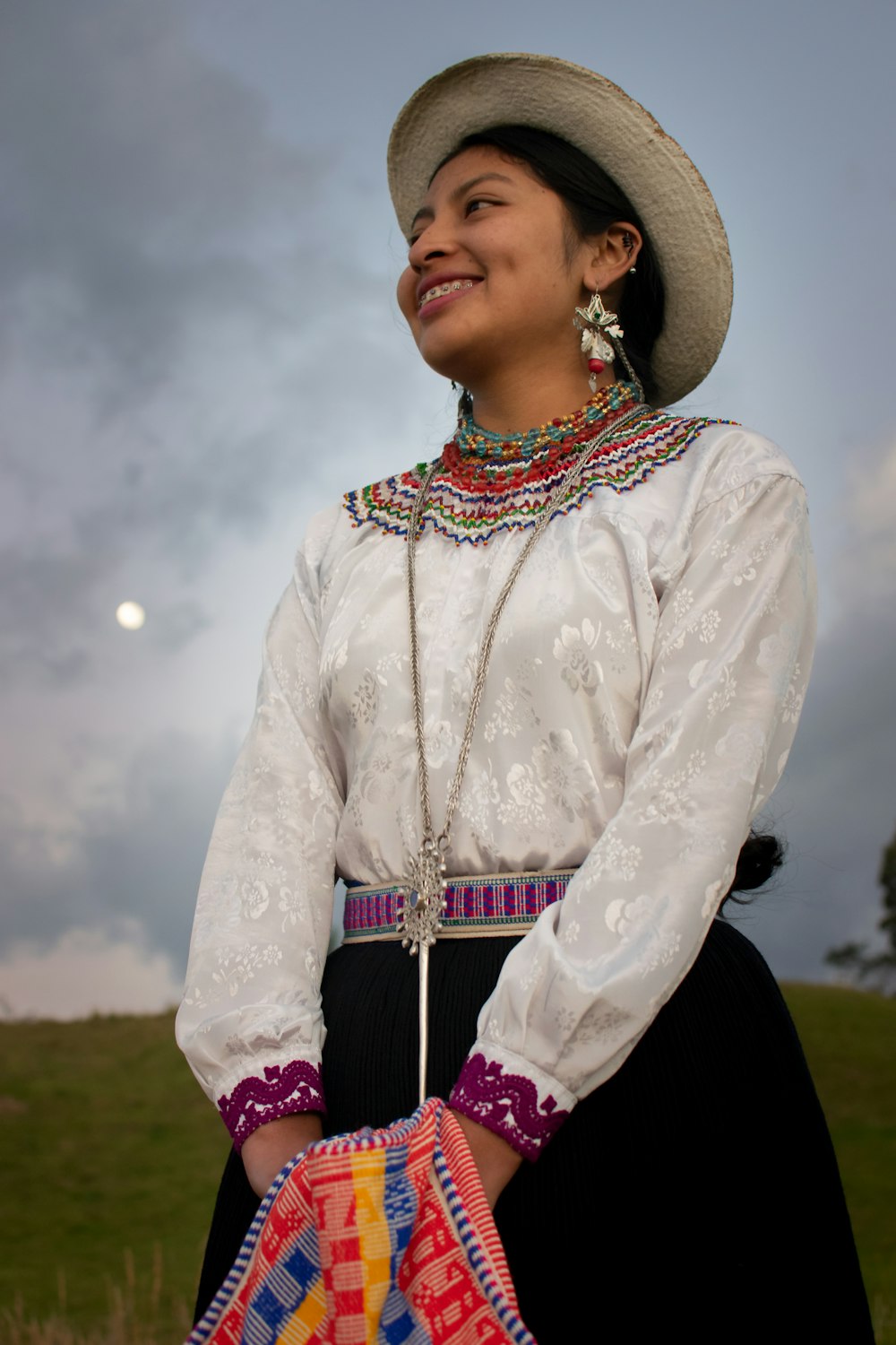 a person wearing a hat and a colorful scarf