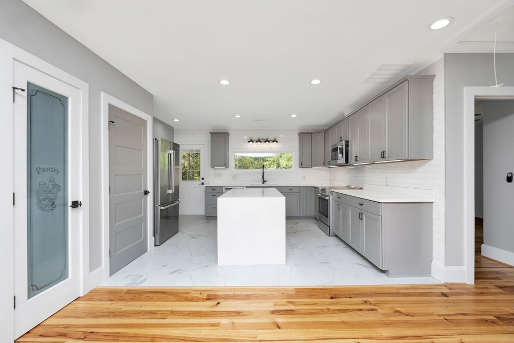 a kitchen with white cabinets