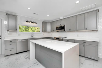 a kitchen with white cabinets