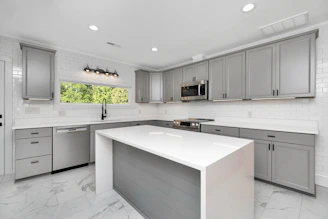a kitchen with white cabinets