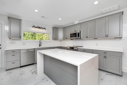 a kitchen with white cabinets