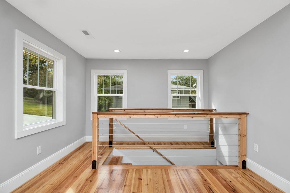 a room with a bench and windows