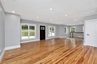 a large empty room with a wood floor and a wood floor