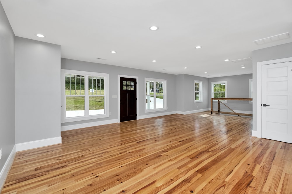 a large empty room with a wood floor and a wood floor