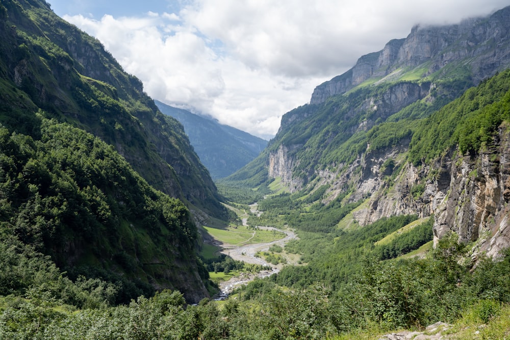 a river running through a valley between mountains