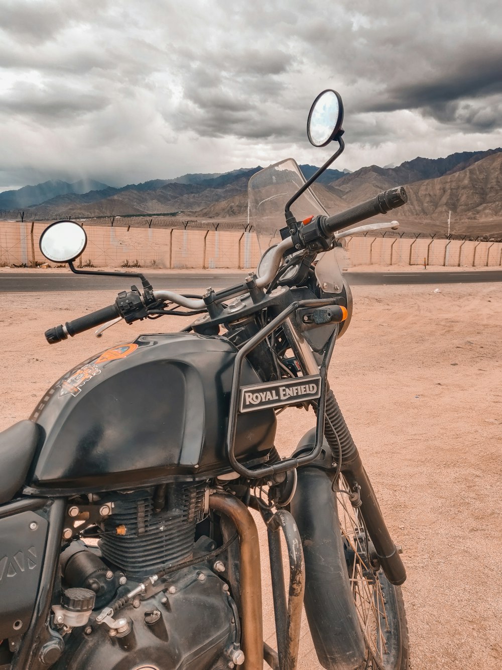 a motorcycle parked on a dirt road