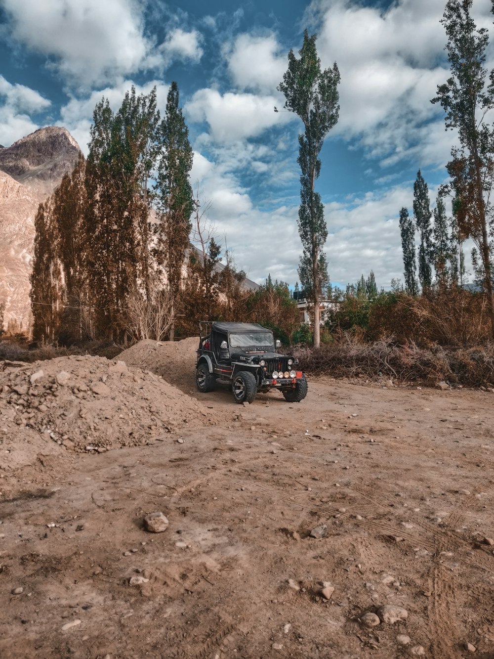 a jeep driving on a dirt road