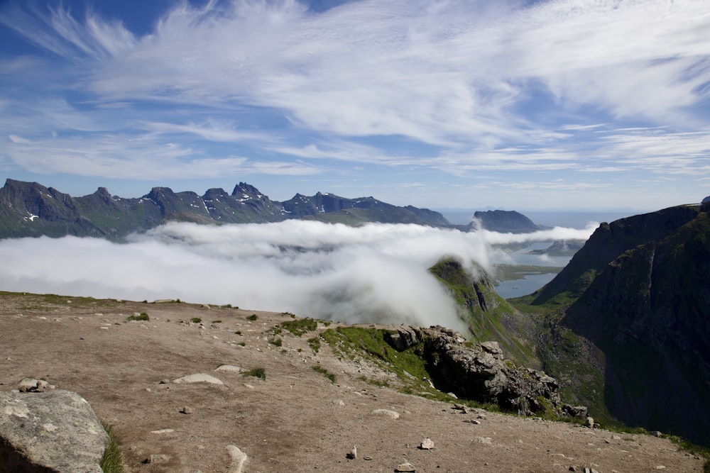 a landscape with mountains and clouds