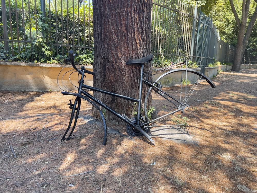 a bicycle leaning against a tree