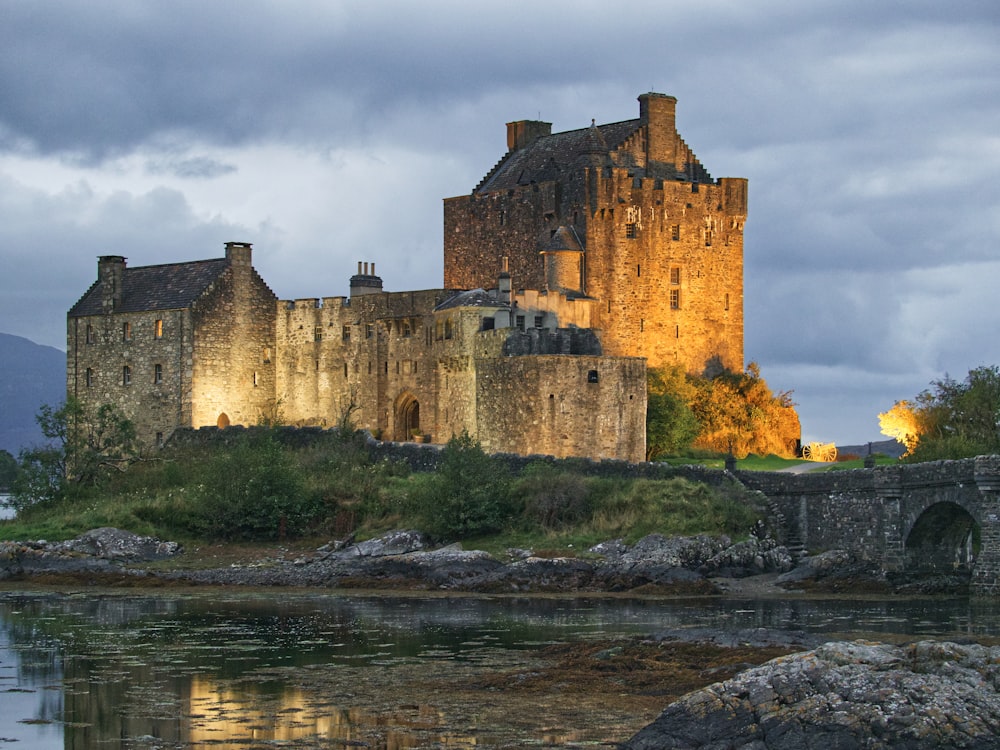 a castle on a hill by water