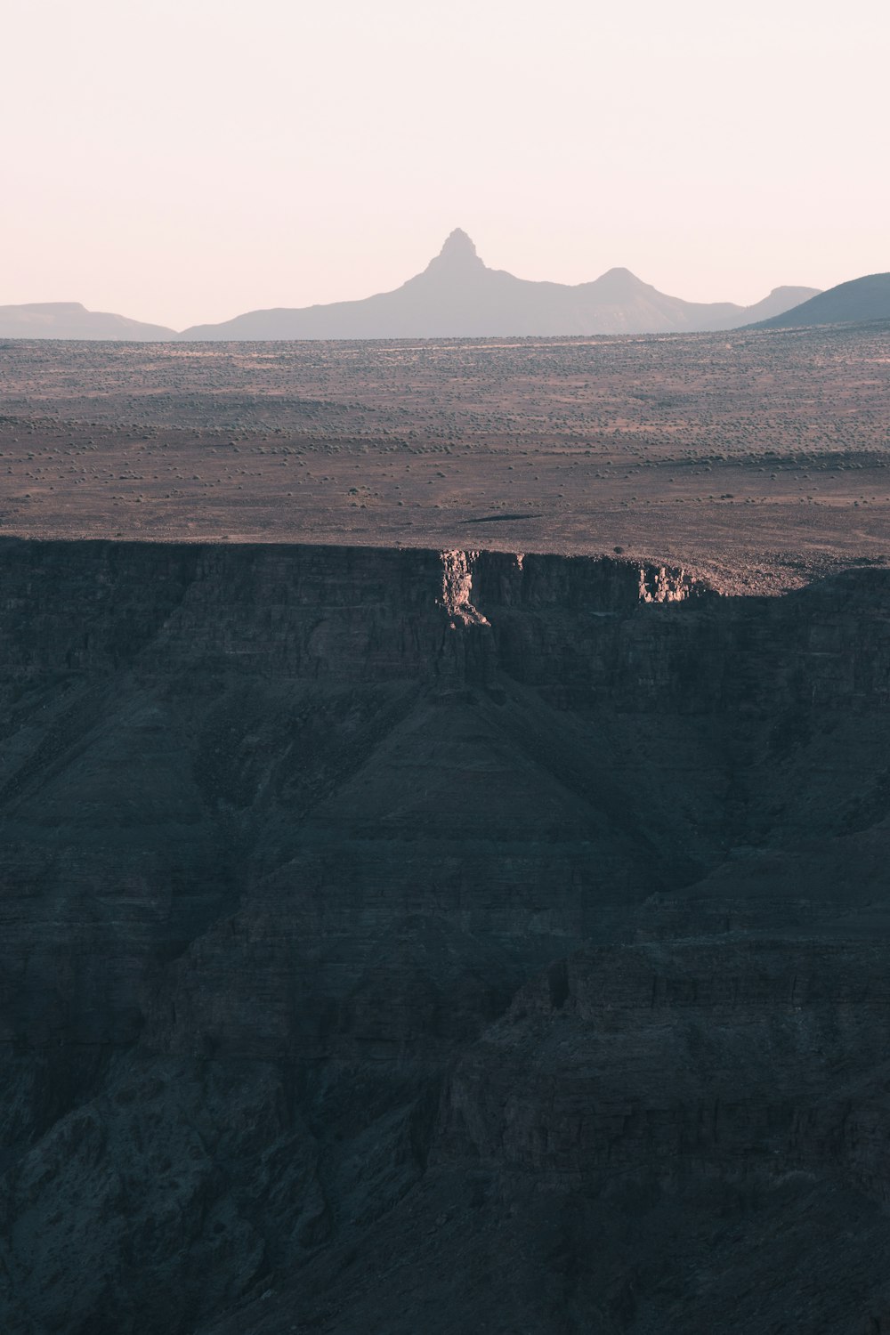 a large mountain with a valley below