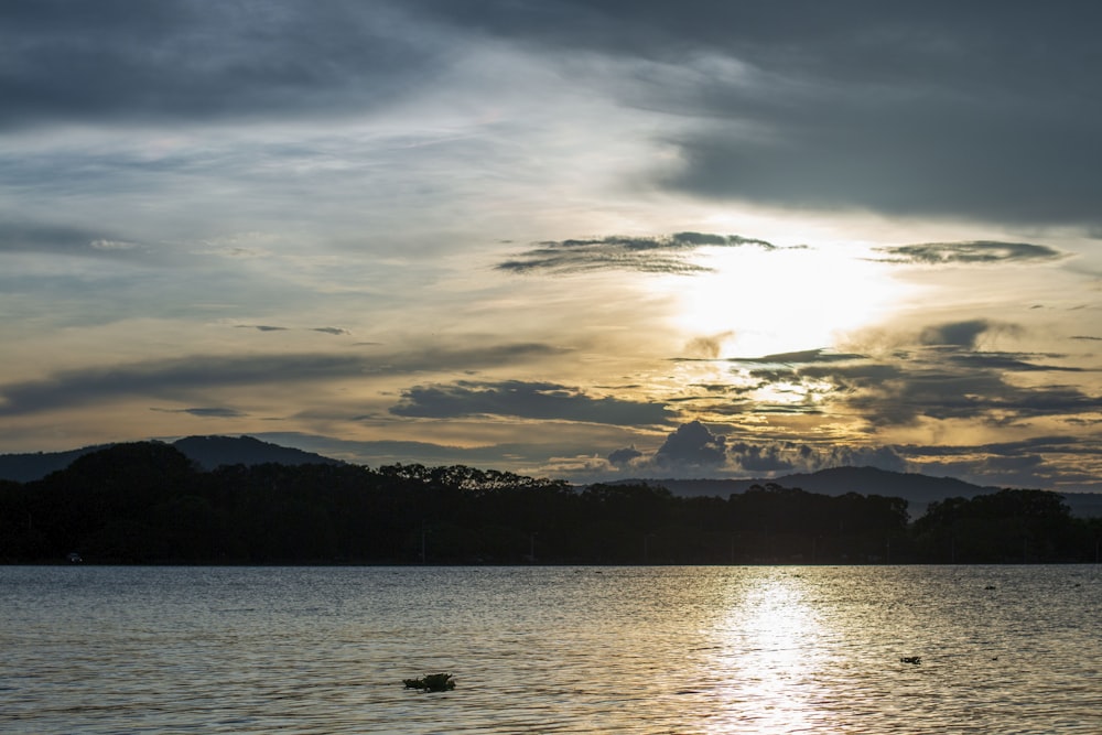 a body of water with mountains in the background