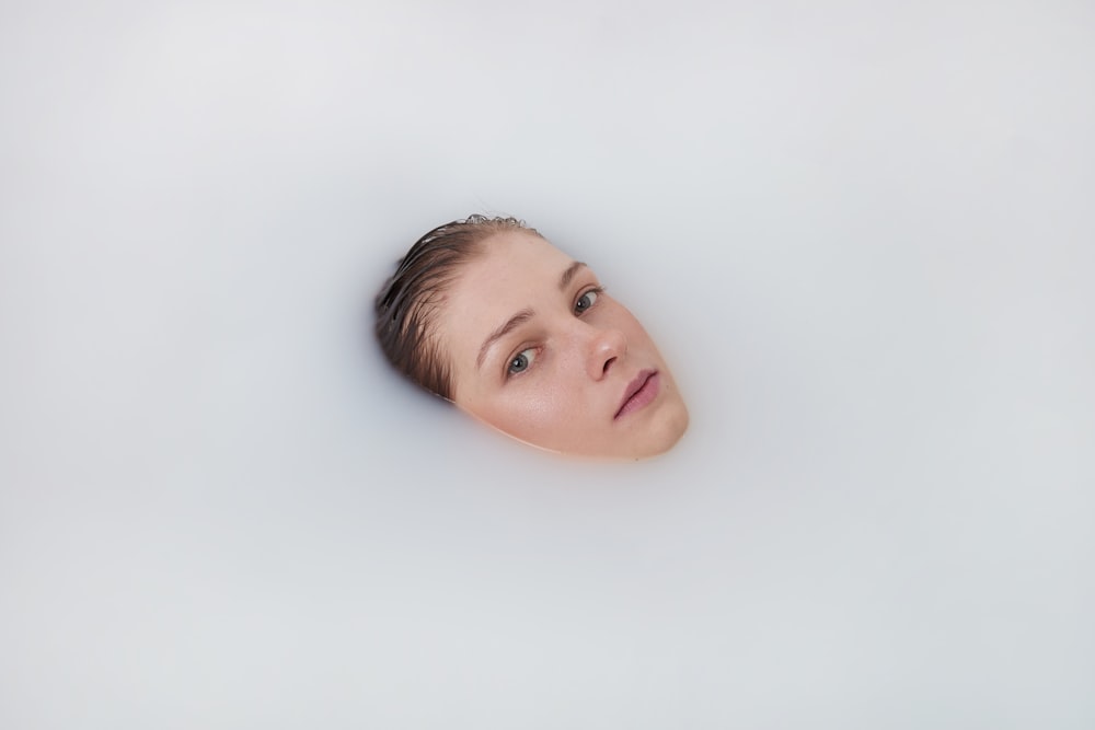 a woman's face in a white background