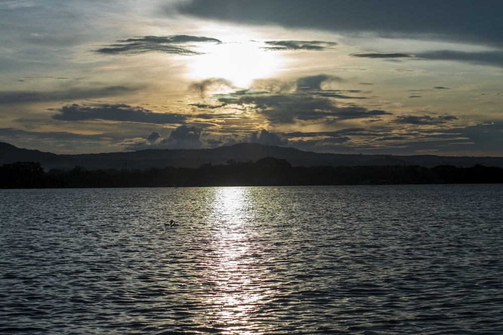 a body of water with mountains in the background