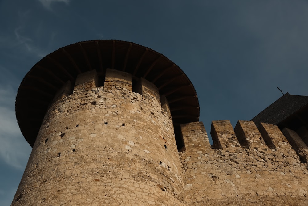 a stone wall with a round tower