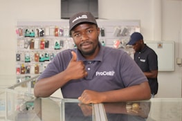 A smiling customer shaking hands with a txap ltd technician after a successful repair.