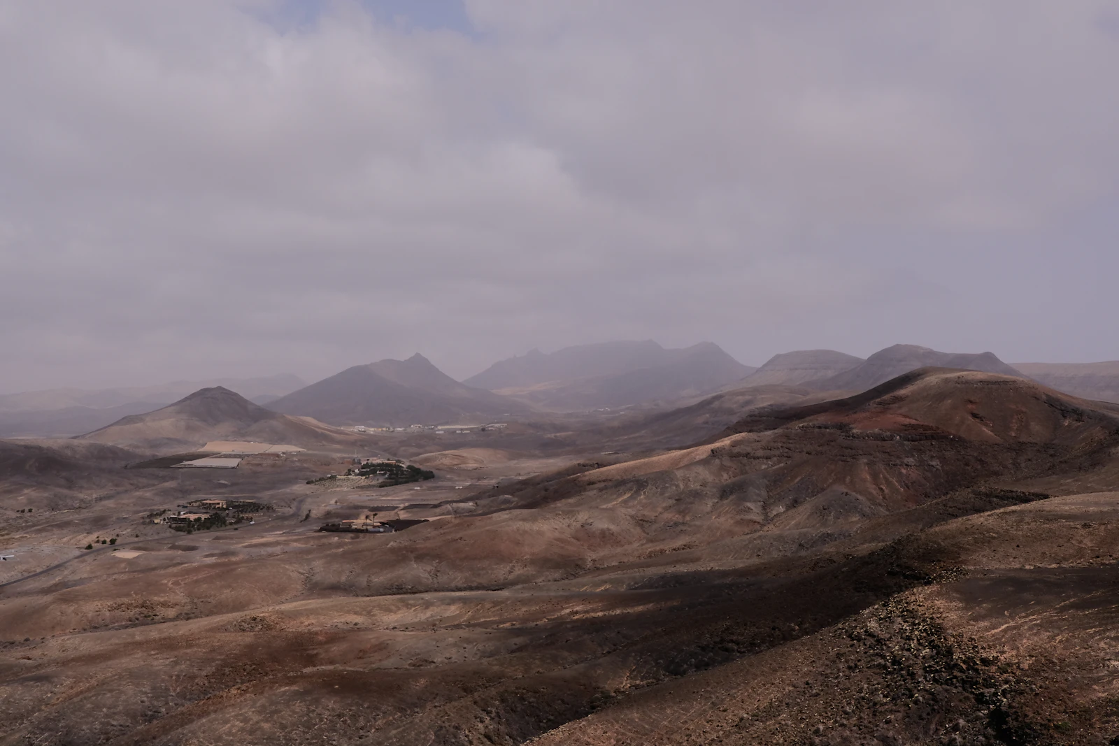 Bare brown volcanic hills under a grey sky — Fuerteventura, Spain