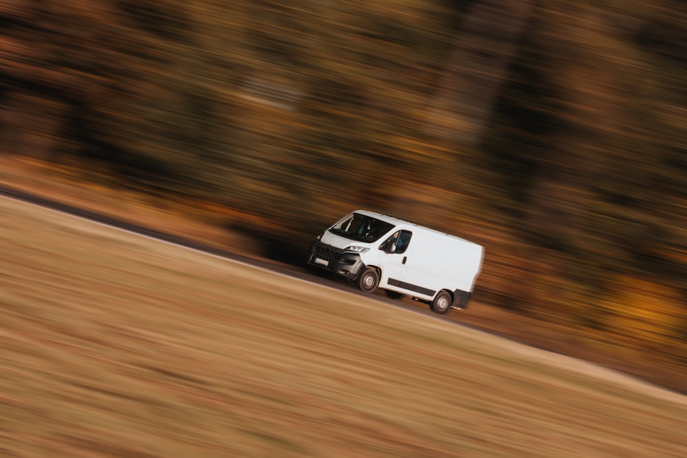 a white car driving on a road