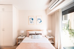 a bedroom with a bed and lamps