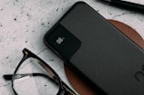 A sleek power bank resting on a traveler's backpack outdoors.