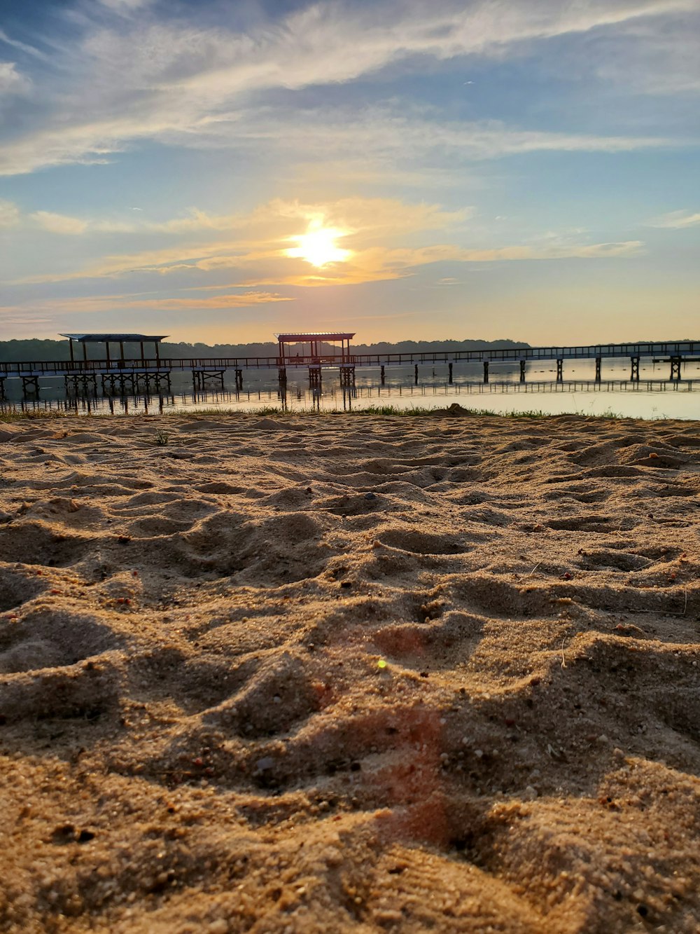 a beach with a pier and water