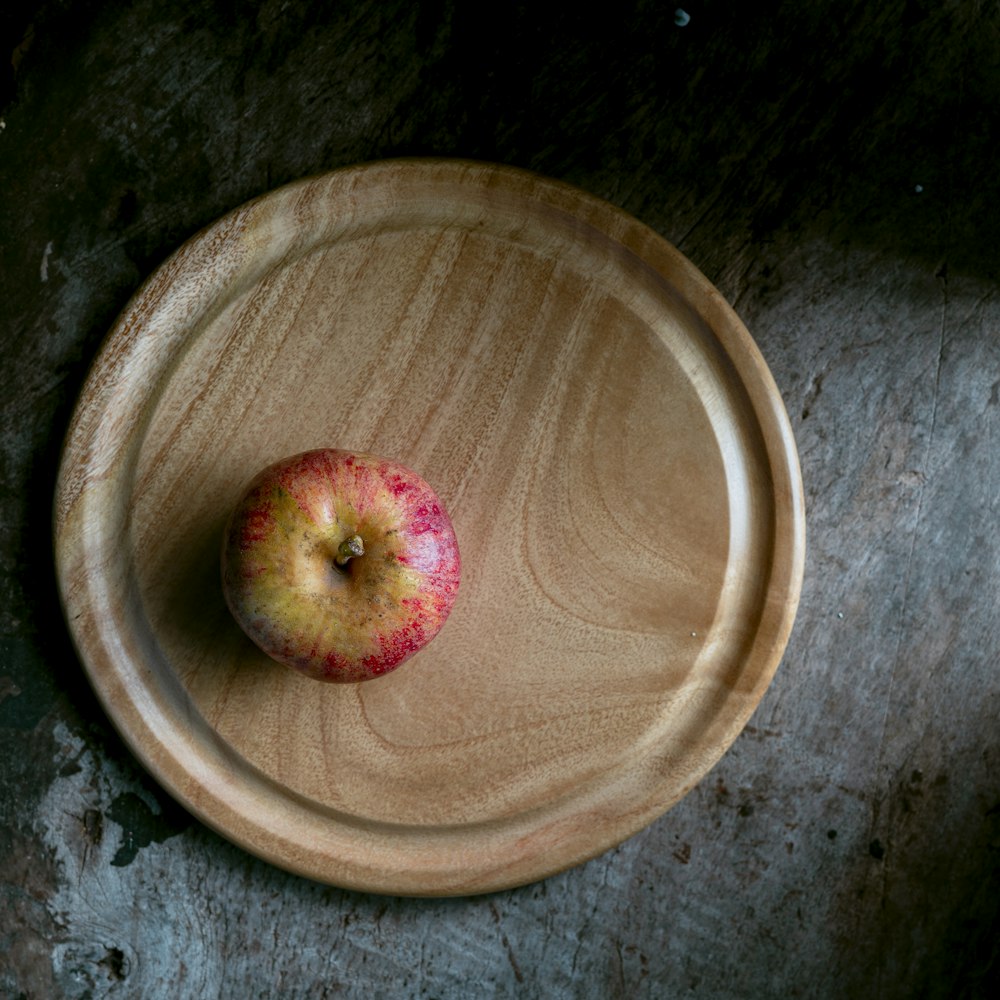 a red apple in a bowl