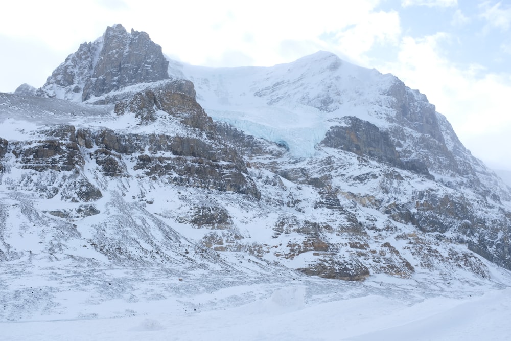 a snowy mountain with a rocky peak