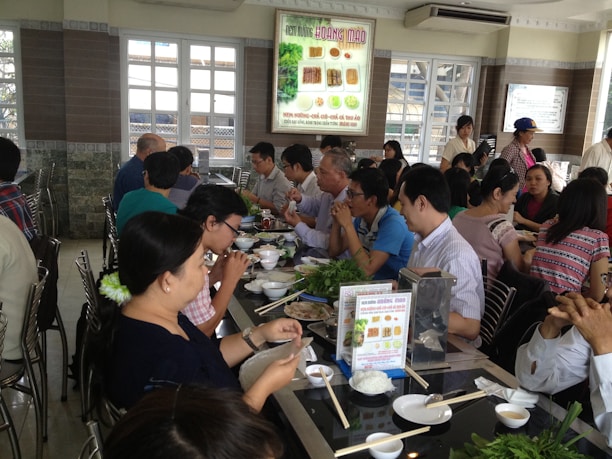 A busy restaurant interior showcasing happy diners enjoying their meals in a lively atmosphere.