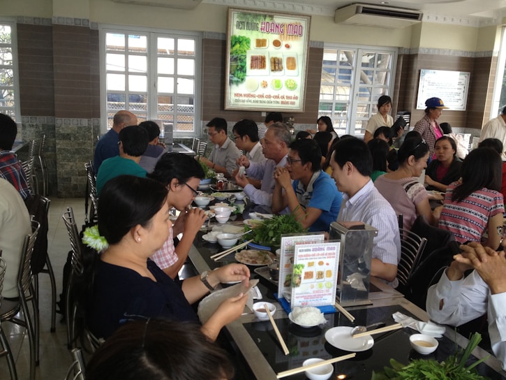 A vibrant restaurant setting with people enjoying their meals.