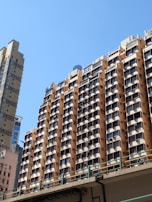 A panoramic shot of a high-rise residential complex in New Delhi under a clear blue sky.