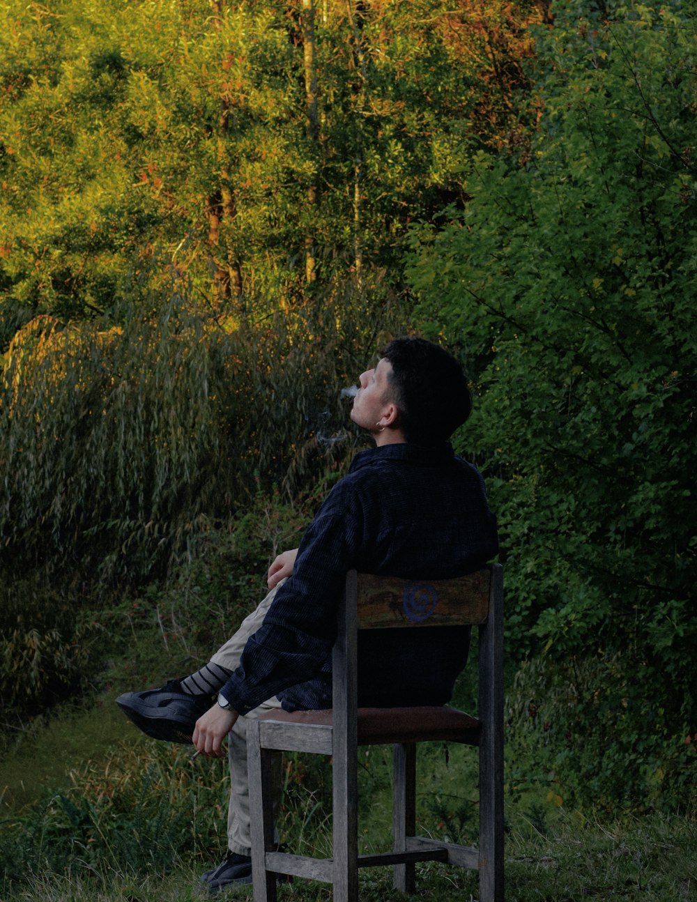 a man sitting in a chair outside