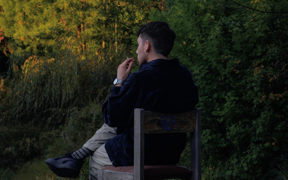 a man sitting on a chair outside