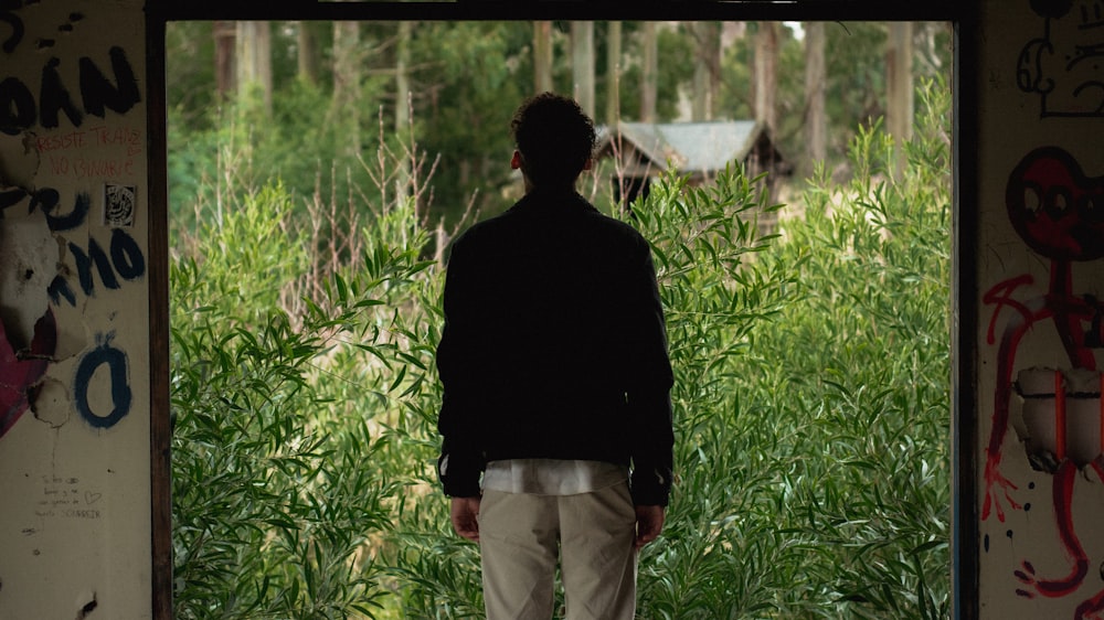 a man walking through a grassy area