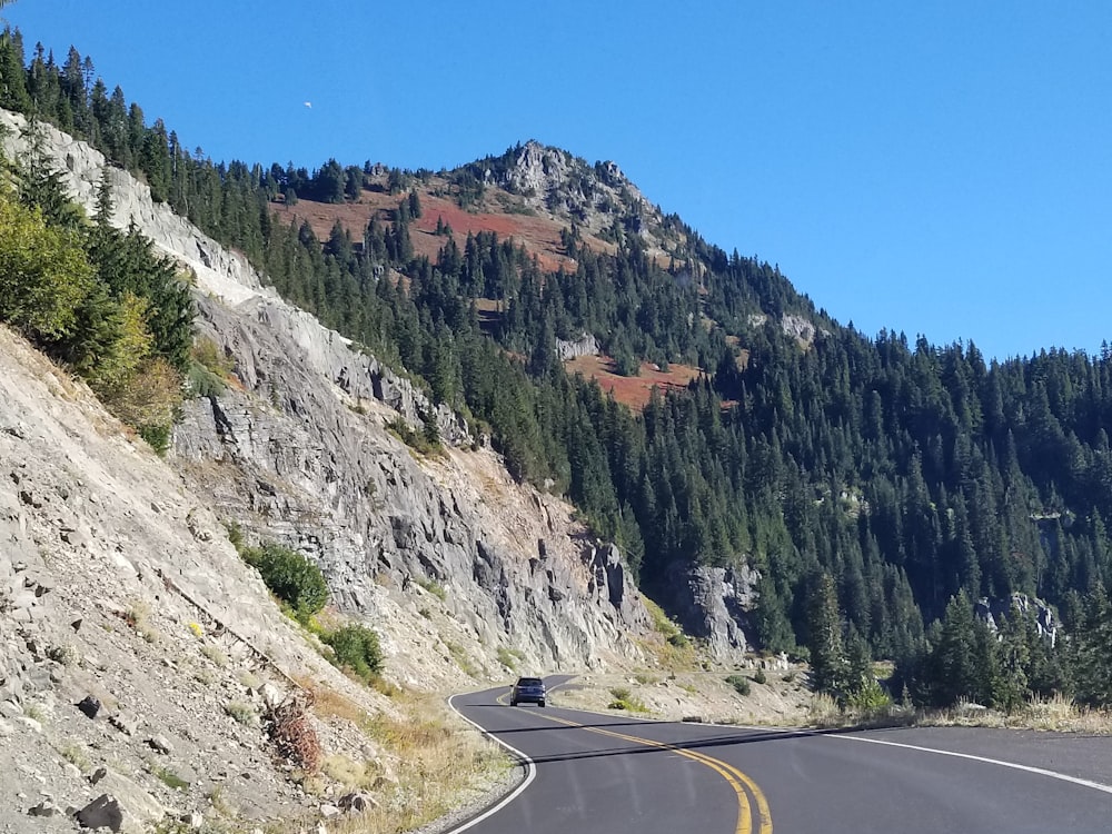 a road next to a mountain