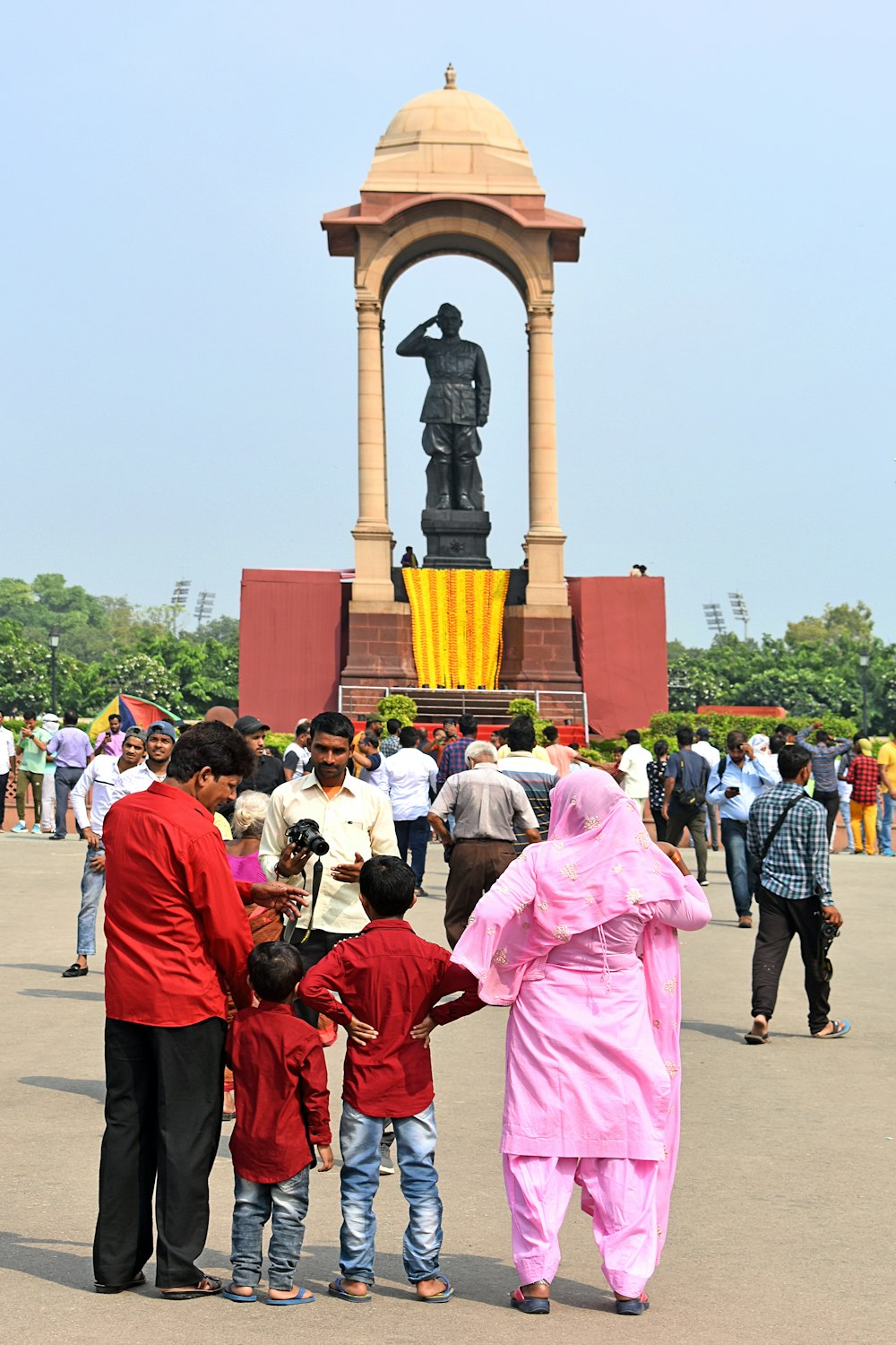 a group of people standing in front of a statue