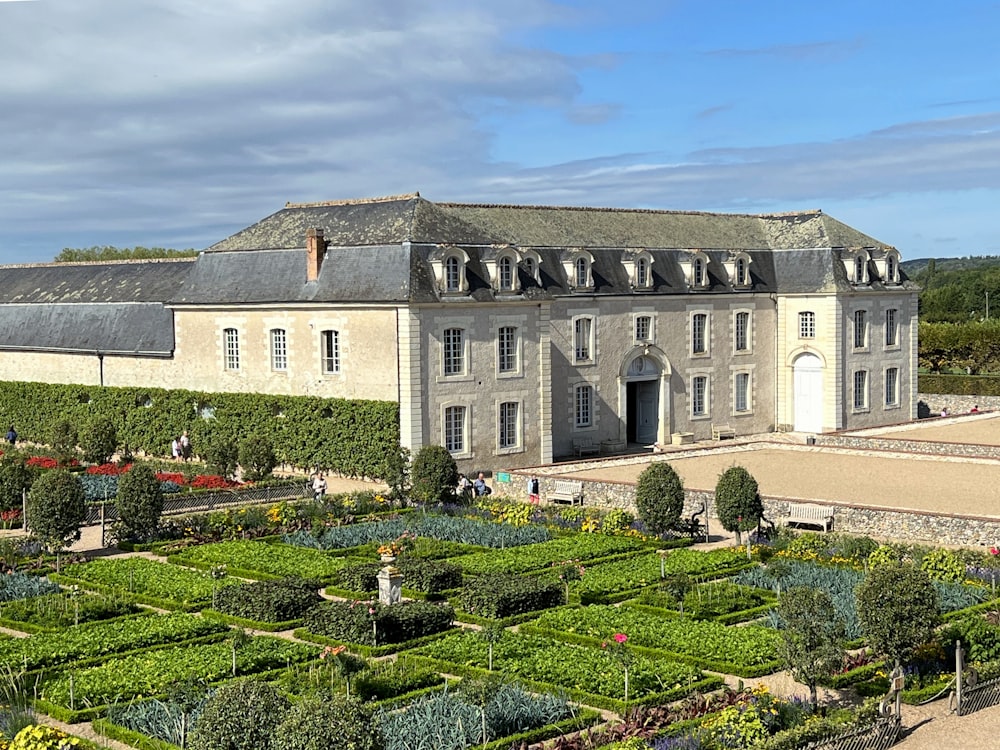 a large building with a garden in front of it