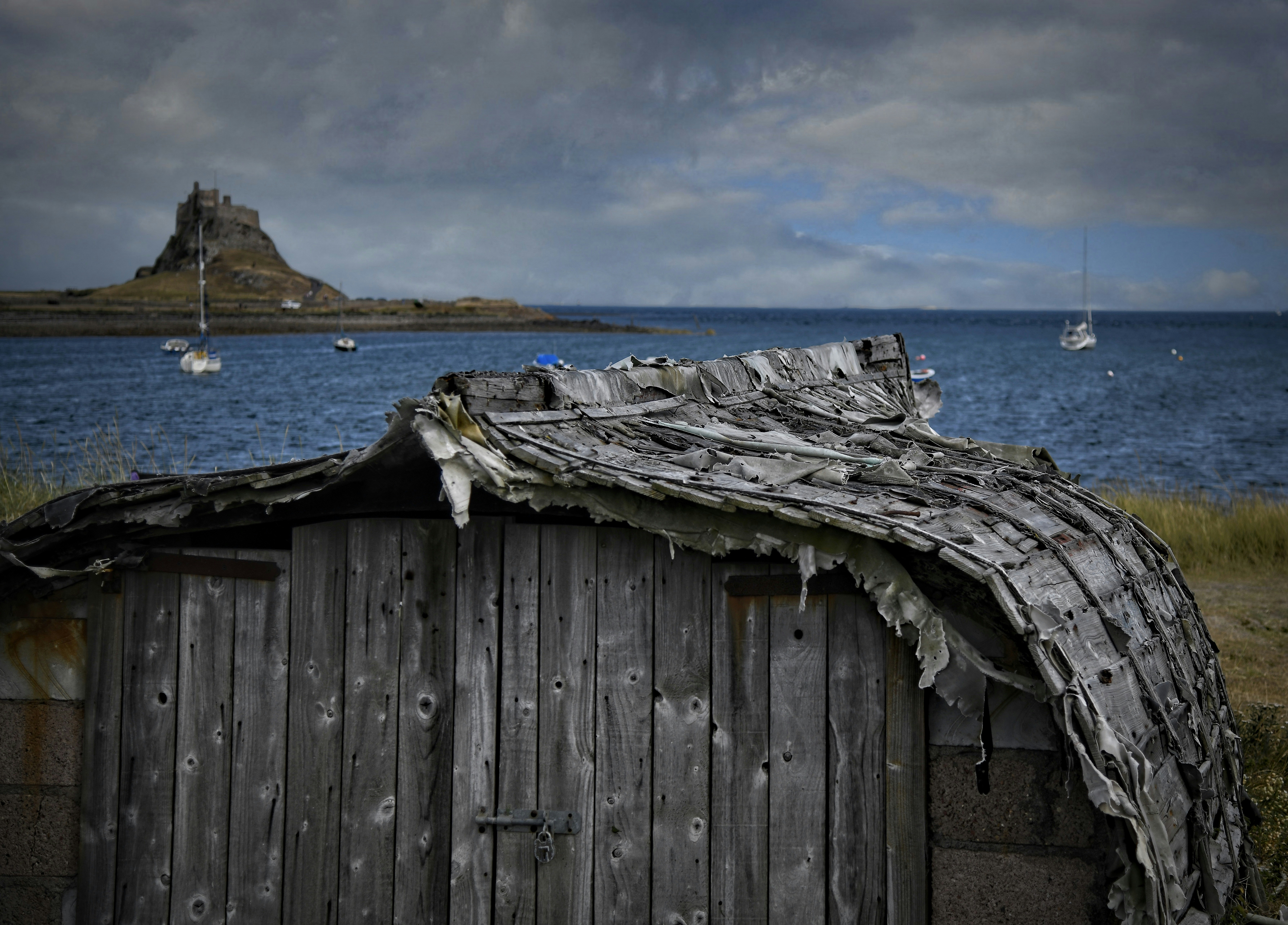 a wooden building with a boat in the water
