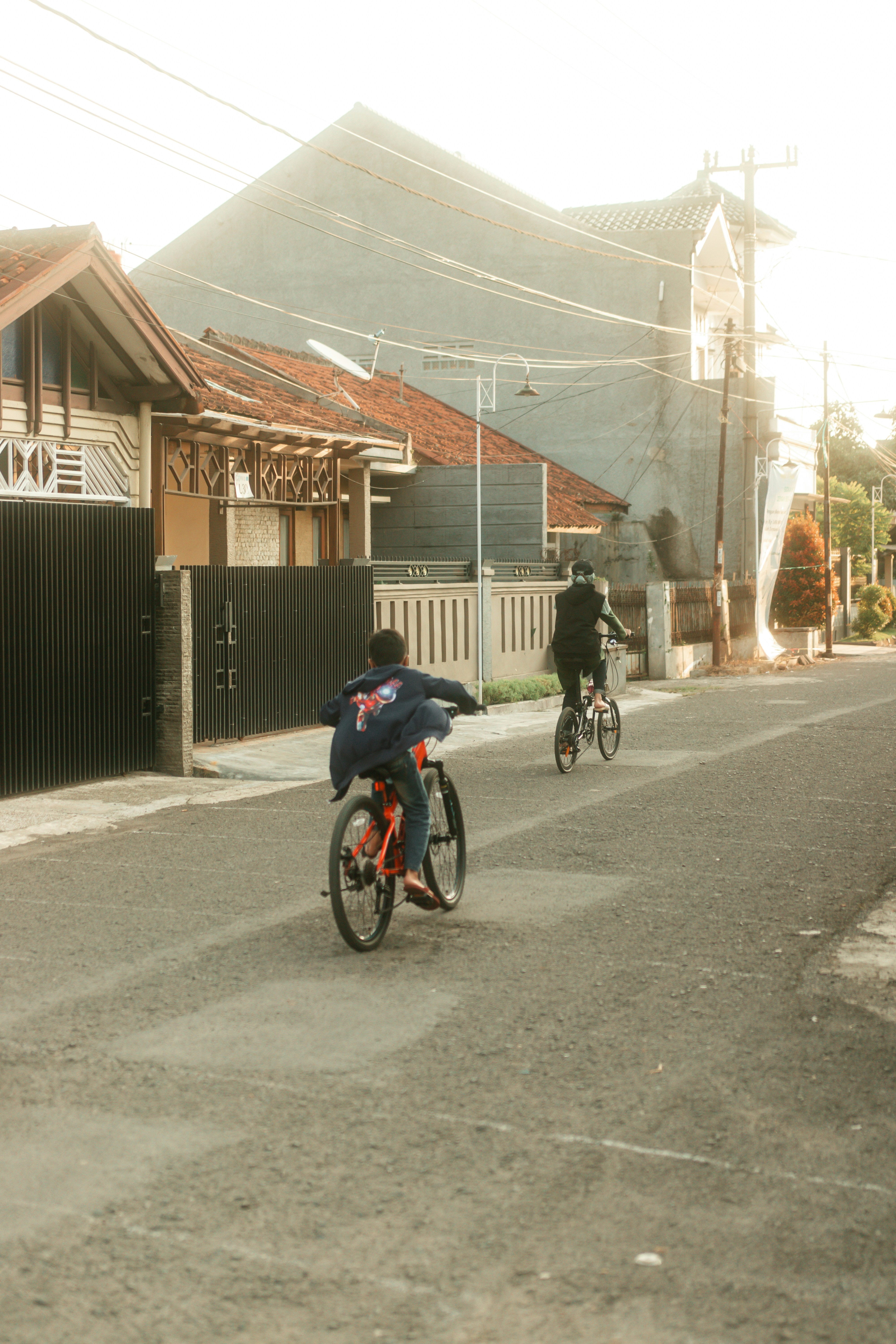 a couple of people riding bikes on a street