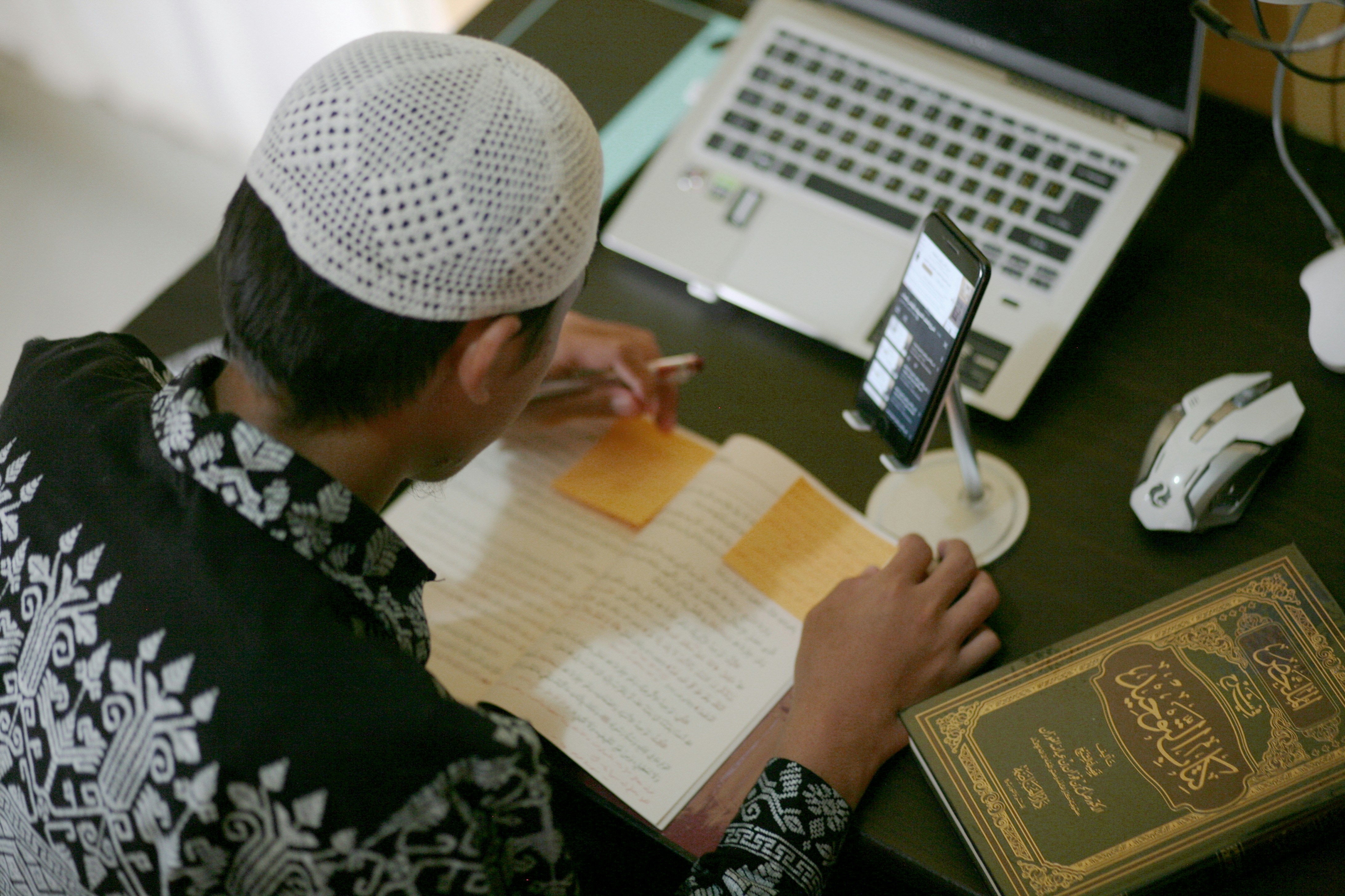 a person writing on a piece of paper
