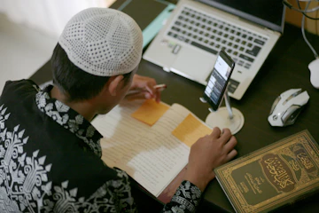 a person writing on a piece of paper