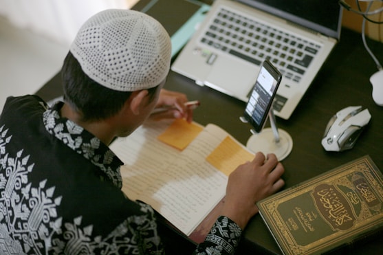 a person writing on a piece of paper