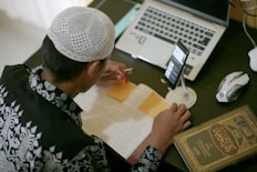 a person writing on a piece of paper