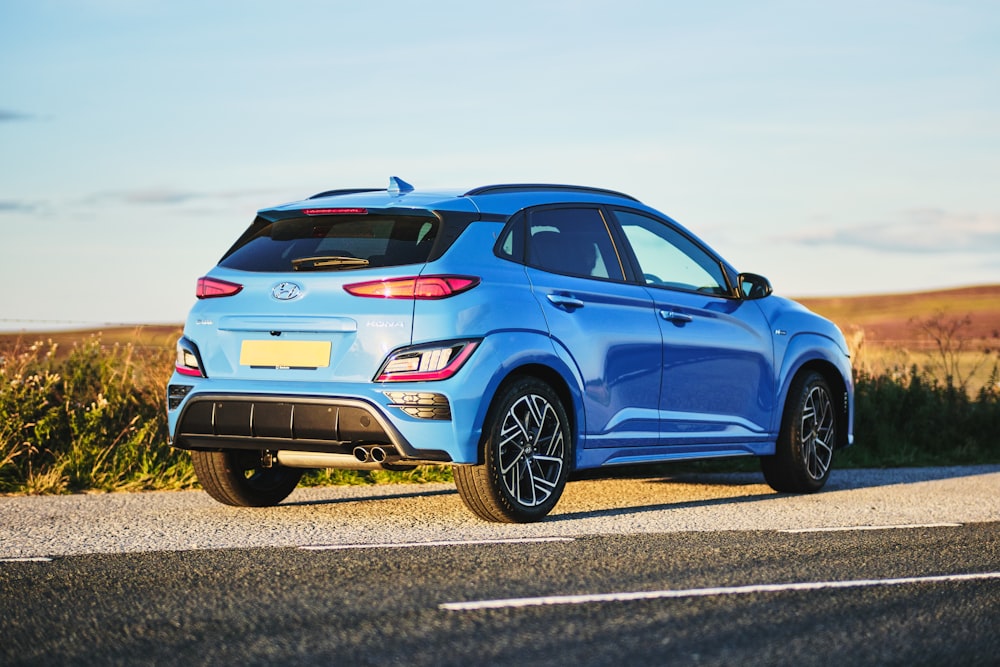 a blue car on a road