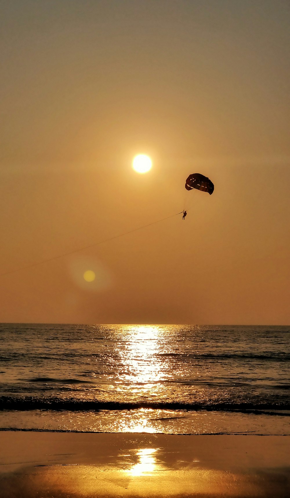 a person parasailing on the beach