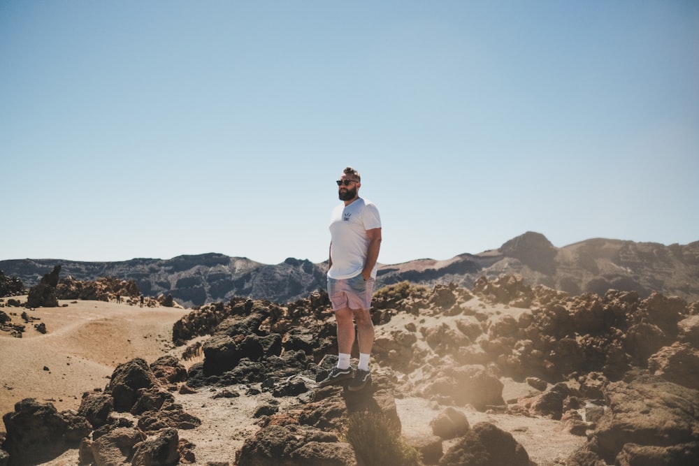 a man standing on a rocky hill