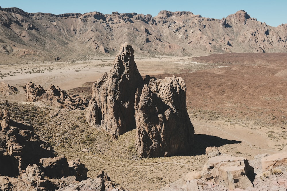 a rocky mountain with a valley below