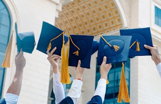 a group of people holding blue and yellow hats